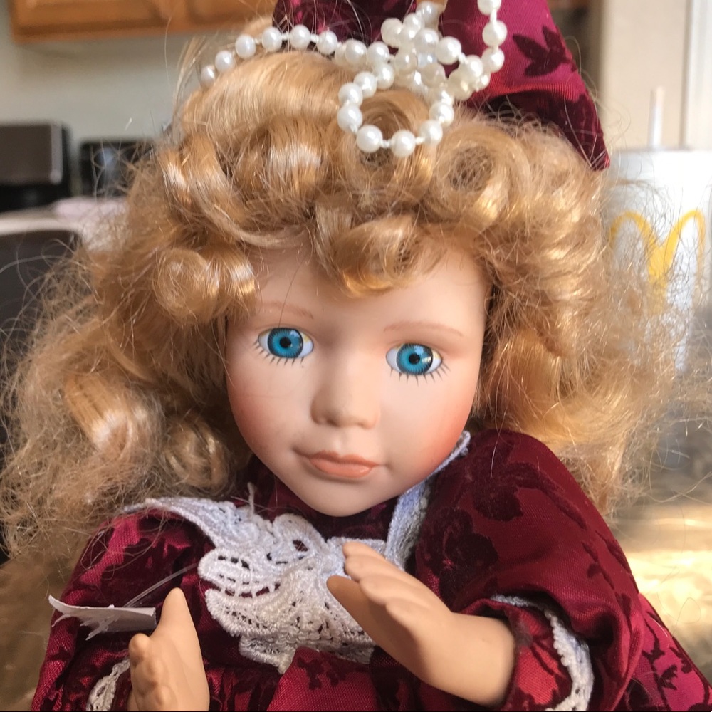 MUSICAL PORCELAIN DOLL.